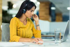 Woman with headphones using laptop