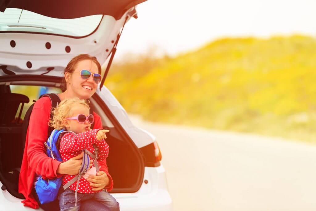 mother and little daughter travel by car