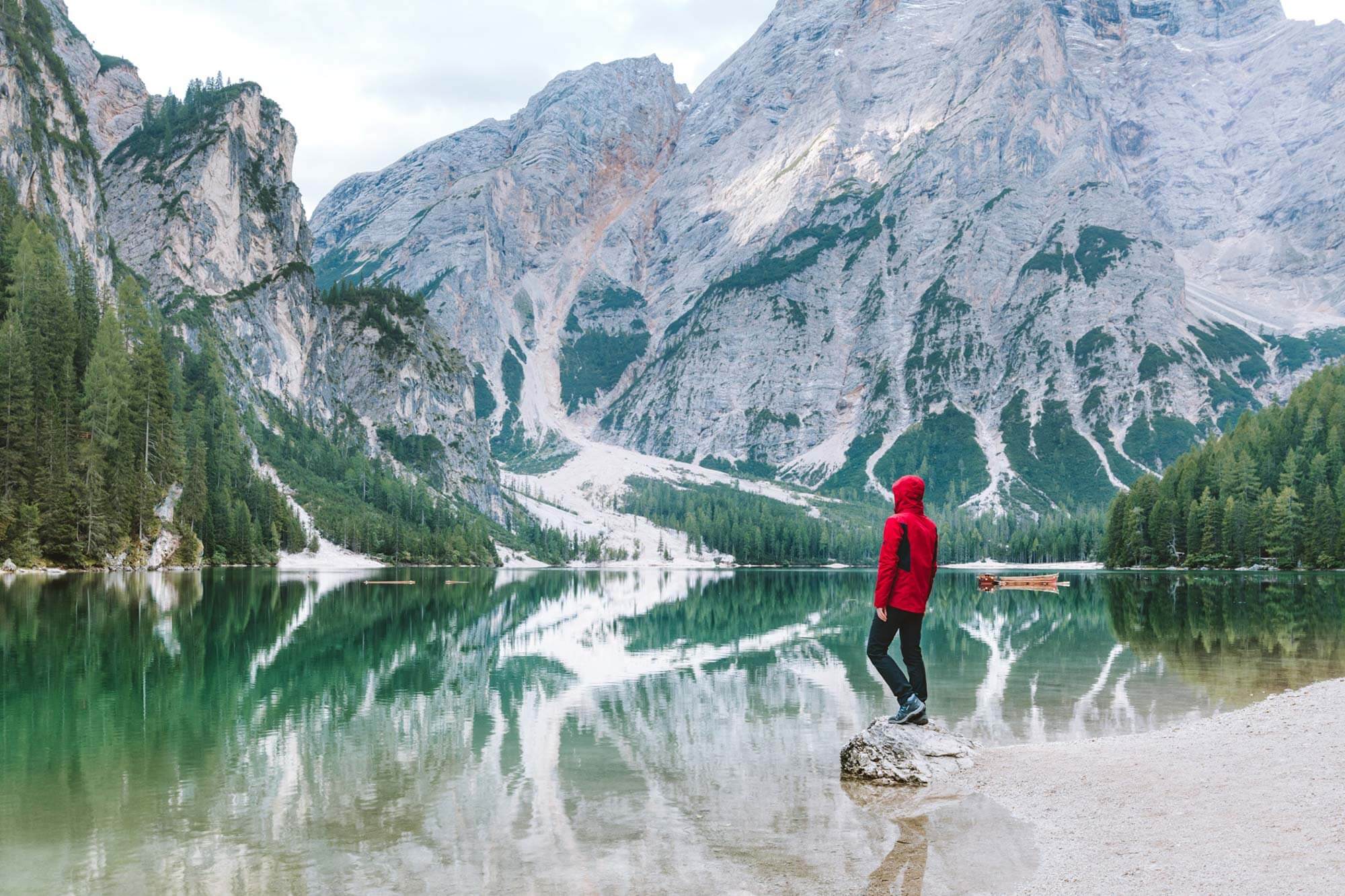 hiker by water and mountains