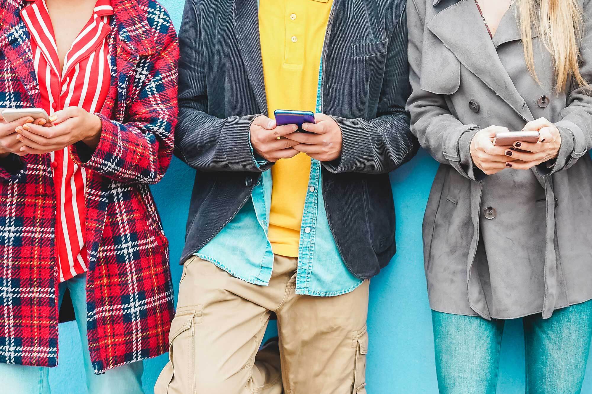 Three youths on their phones